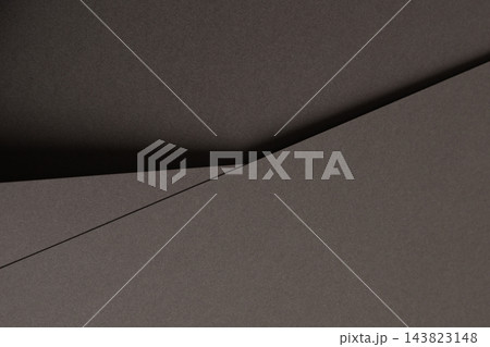Gray paper texture, folded sheet with diagonal fold and crease. Charcoal matte surface close up, overlapping sheets with bent edge and shadow. Monochrome backdrop, geometric shape with grain Gray paper texture, folded sheet with diagonal fold and crease. Charcoal matte surface close up, overlapping sheets with bent edge and shadow. Monochrome backdrop, geometric shape with grain 143823148