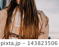 Hair woman trench coat wearing white lace top and beige jacket outdoors during daytime with copy space 143823506