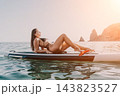 Woman Paddleboard Ocean Relaxing on Paddleboard in Calm Water 143823527