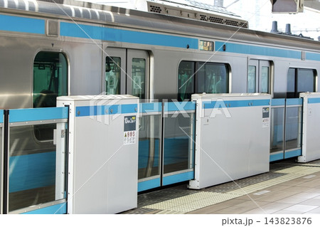 鉄道イメージ、京浜東北線のホームドアの前で列車を待つビジネスマン 143823876