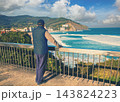 A man standing on the embankment and looking at the ocean and the beautiful bay. Bakio, Biscay, Basque Country, Spain, Europe 143824223