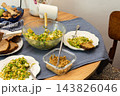 Quinoa with green peas, arugula, cauliflower, and broccoli is served with liver pate at a dining table during breakfast 143826046