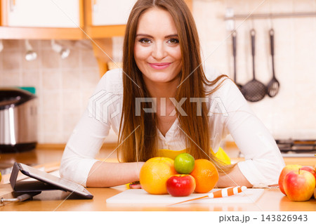 Woman housewife in kitchen using tablet Woman housewife in kitchen using tablet 143826943