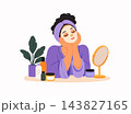 Young woman enjoying a skincare and beauty routine with facial mask, cosmetic products, mirror and towel. Self care, wellness, spa and home beauty treatment concept. 143827165