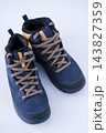 Trekking boots for hiking isolated on a white background. Pair winter shoes top view 143827359