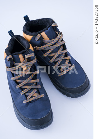Trekking boots for hiking isolated on a white background. Pair winter shoes top view 143827359
