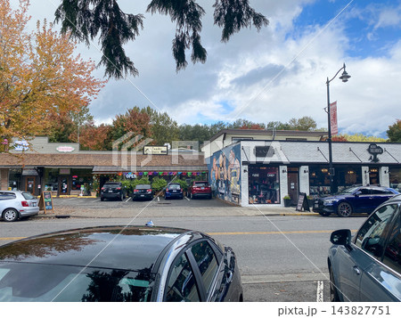 Small town main street with retail shops, parked cars, and autumn trees on a cloudy day - Snoqualmie WA - October 10, 2026 Small town main street with retail shops, parked cars, and autumn trees on a cloudy day - Snoqualmie WA - October 10, 2026 143827751