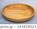 Empty Round Wooden Plate on Gray Concrete background mockup 143828023