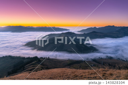Mountain valley covered with fog cloud inversion layer at sunset 143828104