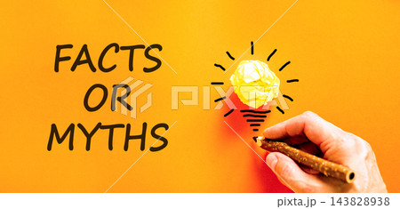 Facts or myths words symbol. Concept words Myths or Facts on beautiful orange paper. Beautiful orange background. Light bulb icon. Businessman hand. Business and facts or myths concept. Copy space. 143828938