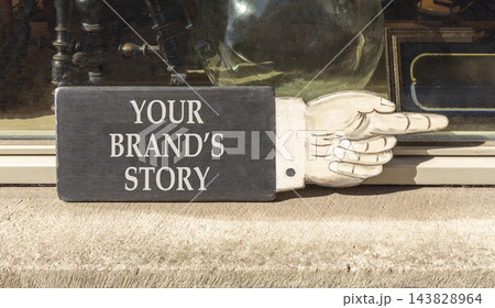 Branding and your brands story symbol. Concept words Your brands story on beautiful black information sign. Beautiful shopfront background. Business branding your brands story concept. Copy space. Branding and your brands story symbol. Concept words Your brands story on beautiful black information sign. Beautiful shopfront background. Business branding your brands story concept. Copy space. 143828964