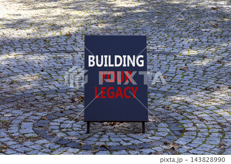 Building your legacy words symbol. Concept words Building your legacy on beautiful black information sign. Beautiful brick road background. Business building your legacy concept. Copy space. Building your legacy words symbol. Concept words Building your legacy on beautiful black information sign. Beautiful brick road background. Business building your legacy concept. Copy space. 143828990