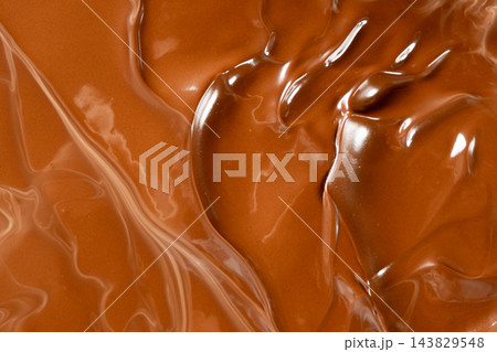 Rich melted chocolate flow background with glossy waves macro view 143829548
