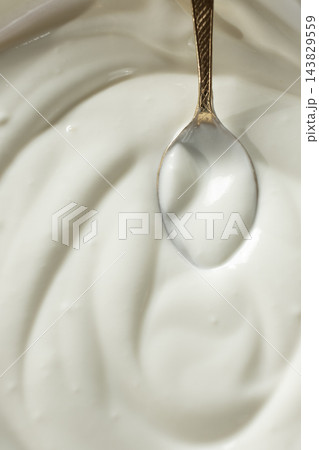 Culinary sour cream milky background. Spoon full of sour cream. Space for text. 143829559