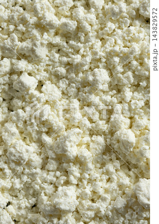 Fresh organic cottage cheese texture background close up Fresh organic cottage cheese texture background close up 143829572