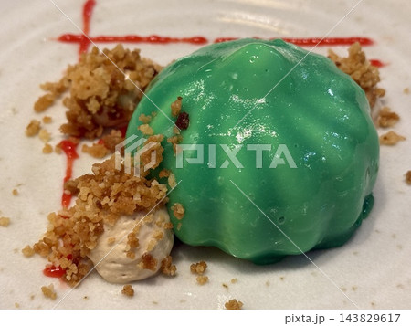 Green Glazed Dessert with Crumble on White Plate Green Glazed Dessert with Crumble on White Plate 143829617