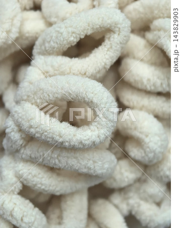 Fluffy white loops create a cozy texture in a warm setting Fluffy white loops create a cozy texture in a warm setting 143829903