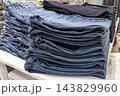 Fashionable denim jeans neatly stacked in a trendy retail store display 143829960