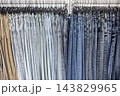 Fashionable denim collection in a vibrant retail store during busy afternoon 143829965
