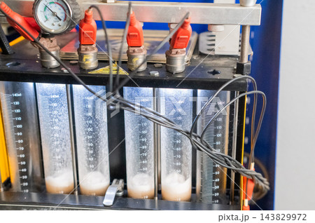 Fuel injector cleaning machine. Car repair. Fuel injector cleaning machine. Car repair. 143829972