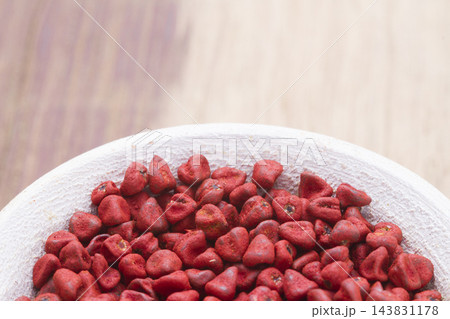 annatto beans in bowl on the table seen from up close annatto beans in bowl on the table seen from up close 143831178