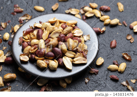 Pile of roasted peanuts on black background, space for text Pile of roasted peanuts on black background, space for text 143831476