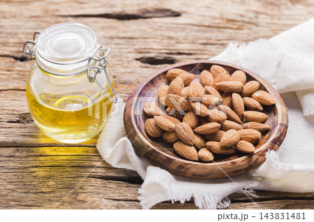 Almond oil and seeds (Prunus dulcis) close-up image 143831481