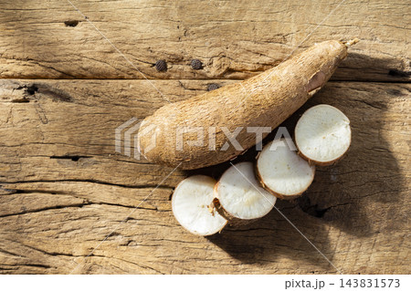 cassava pile, yucca, on a background of rustic wood (Manihot esculenta) 143831573