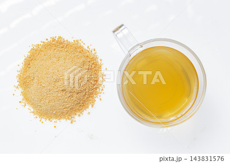 Drink of piloncillo and ground piloncillo, on white background Drink of piloncillo and ground piloncillo, on white background 143831576