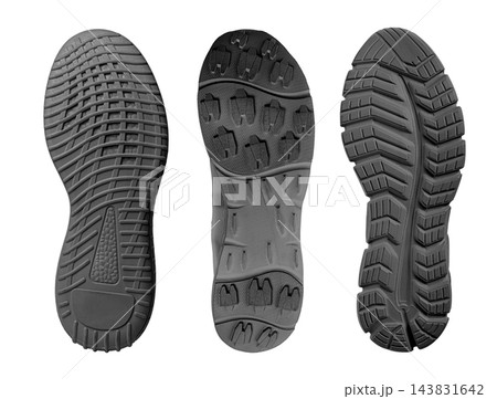 Three athletic shoe soles with varied rubber tread patterns 143831642