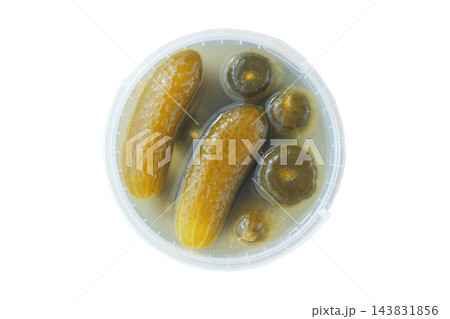 Fermented food. Pickled cucumbers in a plastic container, isolated on a white background. Preserved vegetables and healthy eating. Top view. 143831856