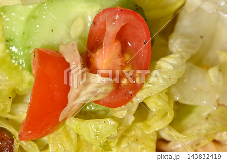 A vibrant close-up macro shot featuring a fresh, colorful salad with finely chopped vegetables 143832419
