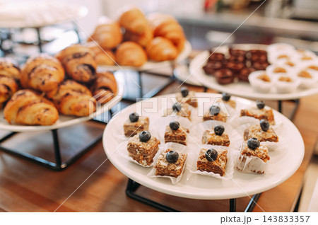 Assorted pastries and mini desserts on a buffet table Assorted pastries and mini desserts on a buffet table 143833357