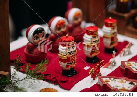 Traditional Christmas nutcracker and festive holiday ornaments on a market display 143833391