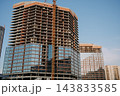 High rise building under construction with tower crane 143833585