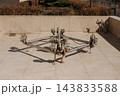 Stainless steel fountain nozzle system installed on a tiled public square 143833588