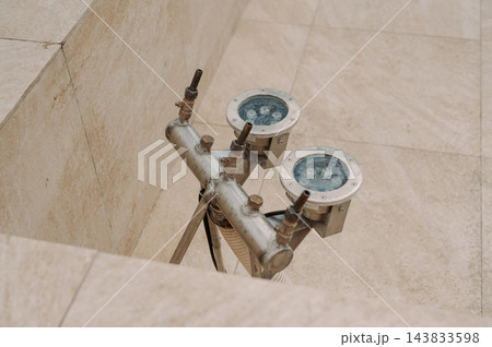 Stainless steel fountain nozzles and plumbing system in an urban public square 143833598