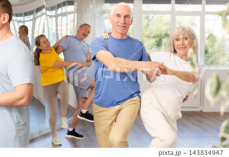 Couple of elderly man and woman dancing twist 143834947