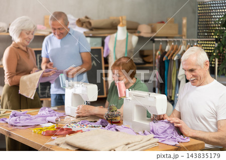 Some people communicate and discuss pattern, while others sew using sewing machine at lesson 143835179