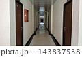 Long Narrow Hotel Corridor Hallway Interior with Wooden Doors Perspective    143837538