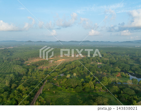 Aerial view of green tropical forest, rubber plantation and farmland. Sustainable agriculture, land use, biodiversity and natural resources. Sustainability and rural development. Land management. Aerial view of green tropical forest, rubber plantation and farmland. Sustainable agriculture, land use, biodiversity and natural resources. Sustainability and rural development. Land management. 143838021
