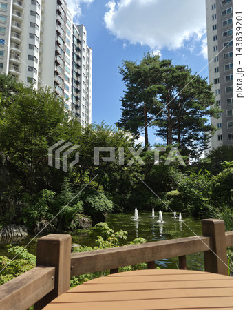 It is a garden with a pond within the apartment complex. It is a garden with a pond within the apartment complex. 143839201