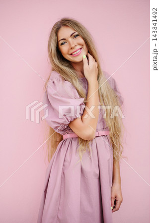 Cheerful Woman With Long Hair By Pink Wall Cheerful Woman With Long Hair By Pink Wall 143841492