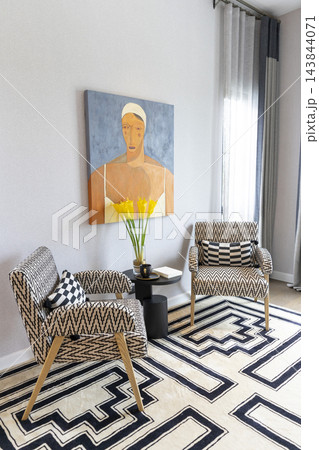 Two lounge chair and carpet rug with black and white graphic pattern in modern home. 143844071