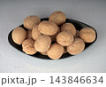 High angle view of raw unshelled walnuts served in a black oval dish on a white background 143846634