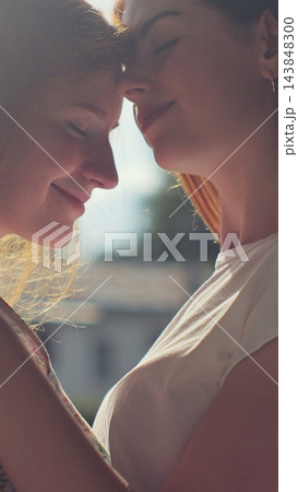 Vertical video. Two young lesbian women Embracing and kissing each other. Vertical video. Two young lesbian women Embracing and kissing each other. 143848300