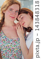 Vertical video. Lesbian couple closeup spending romantic time together standing on street. 143848318