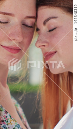 Vertical video. Two lesbian woman lgbt couple hugging, kissing. Concept of LGBT happiness, freedom, love couple. 143848319