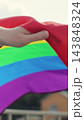 Vertical video. Close up young woman waving the rainbow LGBT Flag during pride parade. 143848324