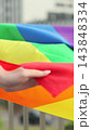 Vertical video. Woman waving rainbow flag during lgbt pride parade. Close up waving the rainbow LGBT Flag. 143848334